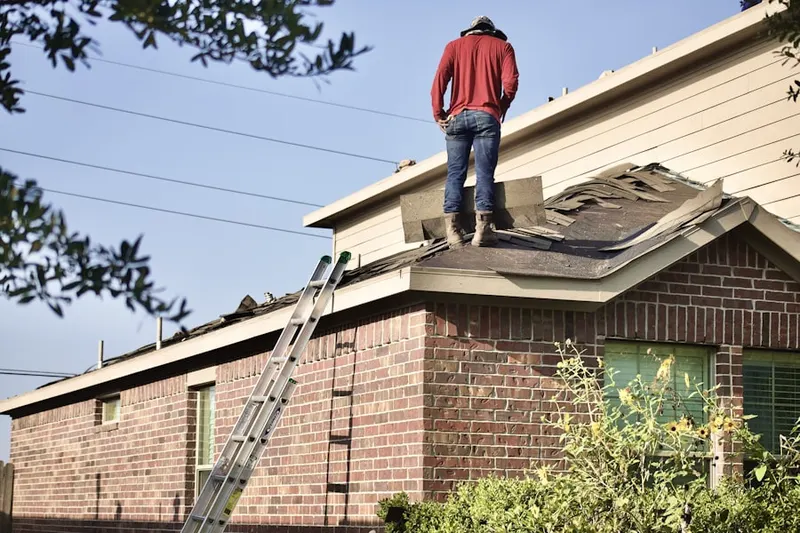 Professional roofer working on a residential roof in Rockefellows Mills